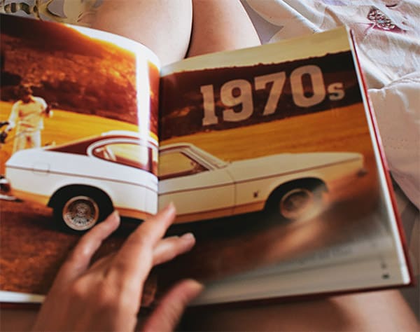Reading vintage car magazine