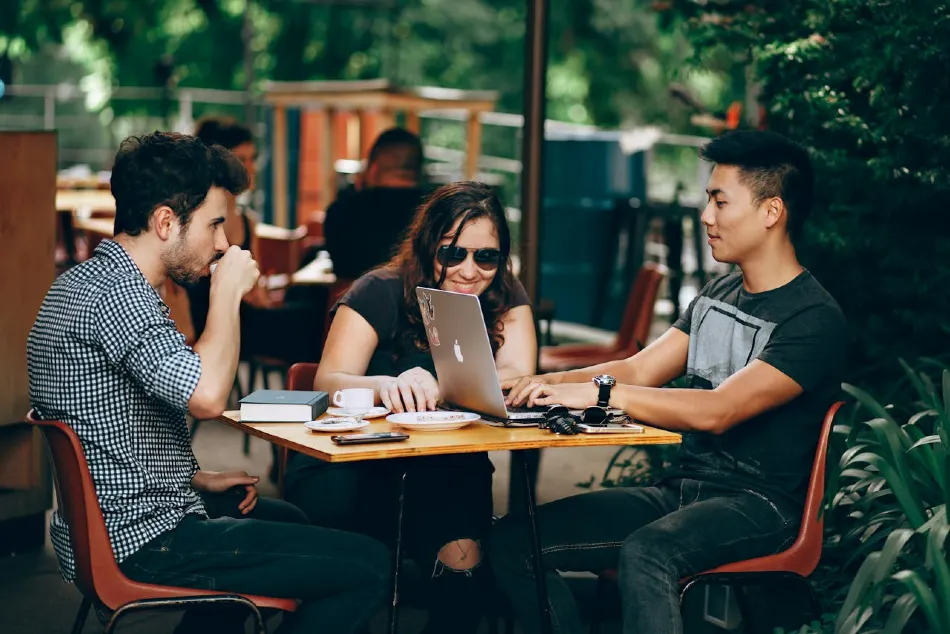 Coffee shop owner sat at table strategizing marketing plans