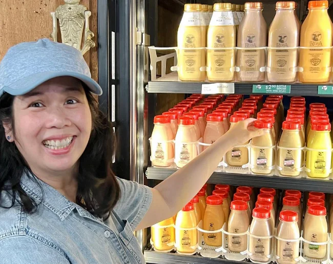Cristie Lo displaying a fridge full of Rosa flavored milk