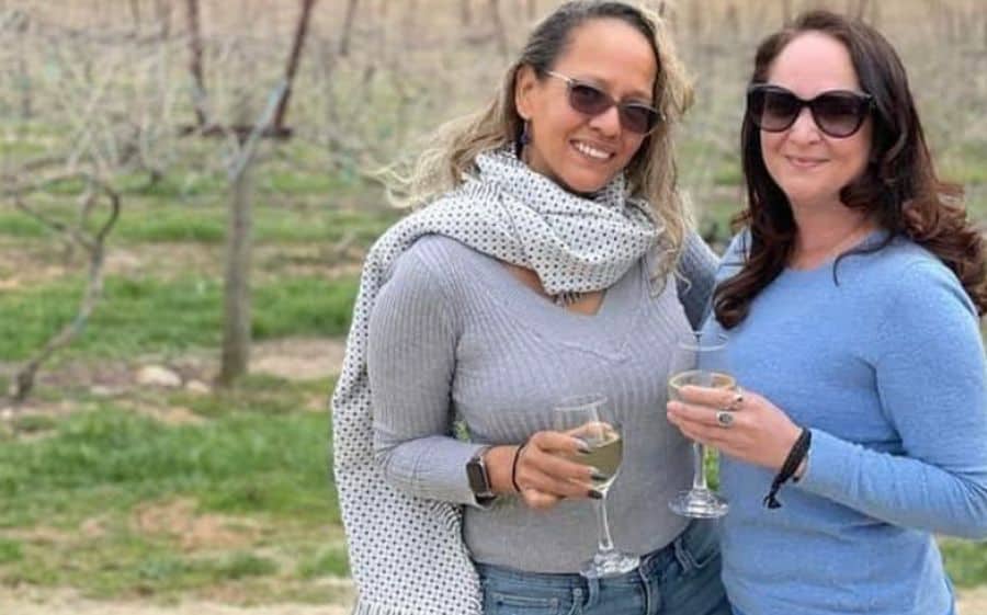 Jennifer Quillen with her friend outdoors drinking white wine