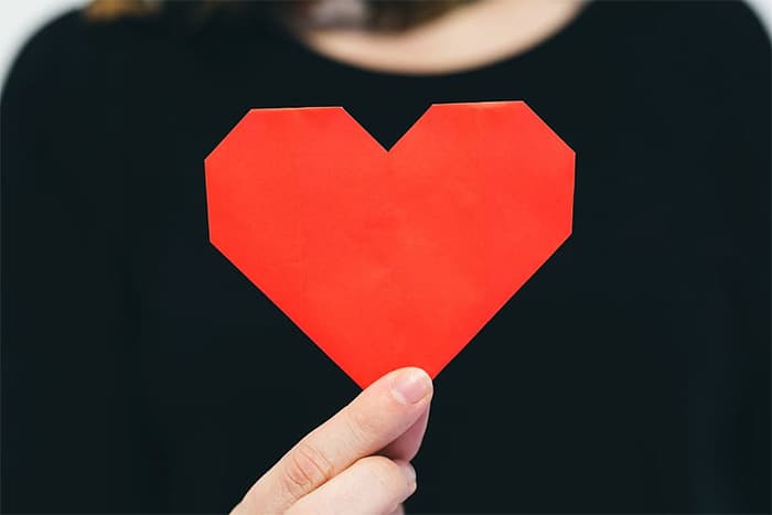 Hand holding origami heart | Inspiring Social Media Followers